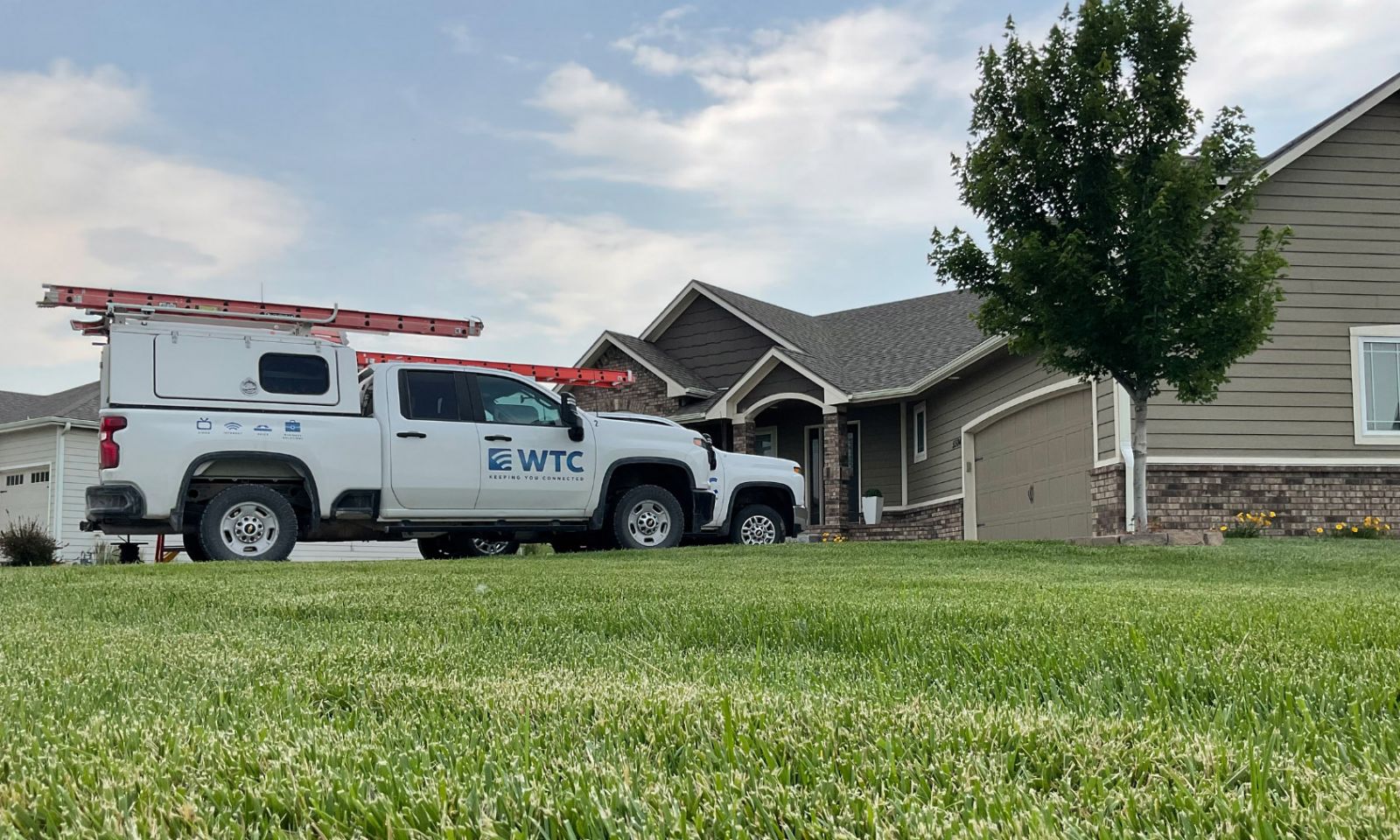 WTC service truck parked outside of a house